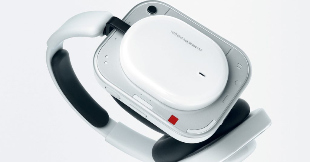 A close-up, detailed shot of the white Nothing Headphone (a), focusing on the right earcup's transparent outer casing.