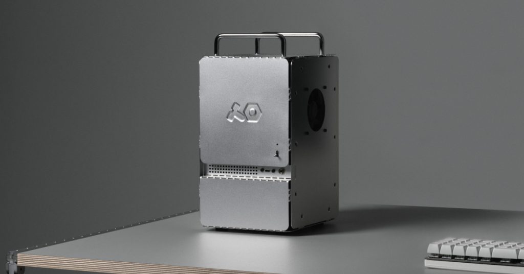 Front-facing view of the assembled Teenage Engineering Computer-1 aluminum mini-ITX case sitting on a minimalist desk, highlighting the embossed 